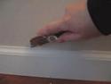 Utility knife on baseboard