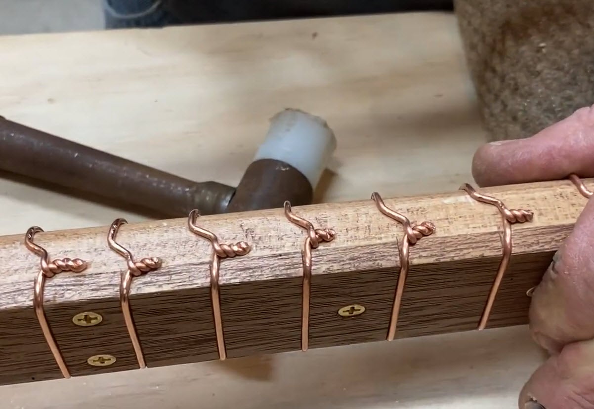 Copper wire frets on a cigar box guitar